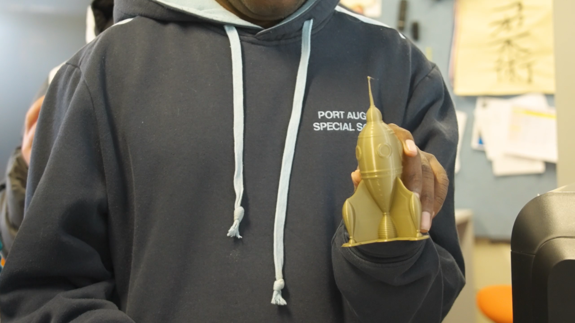 Student holding a 3D printed rocket.